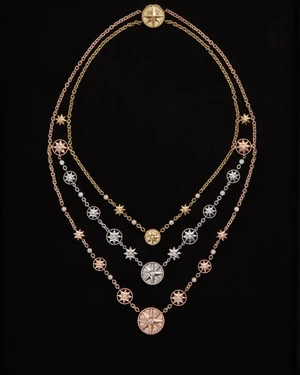 Three layered gold and diamond star-shaped medallion necklaces displayed against a solid black background.