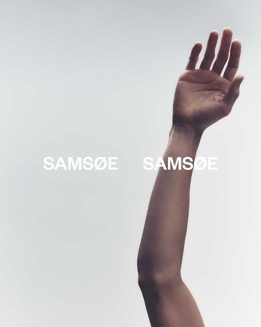 Fashion shot features a raised arm against a light background, highlighting skin tones and subtle texture. 'Samsøe Samsøe' text overlays.
