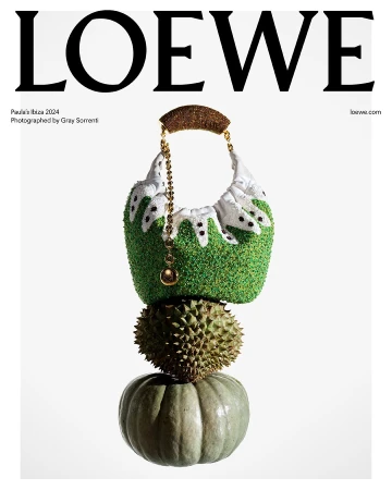Loewe handbag with textured green and white design, durian, and pumpkin stacked on a white background, studio lighting for fashion editorial.