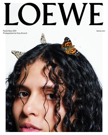 Fashion editorial image featuring a young woman with curly hair adorned with butterflies, promoting LOEWE Paula's Ibiza 2024 collection.