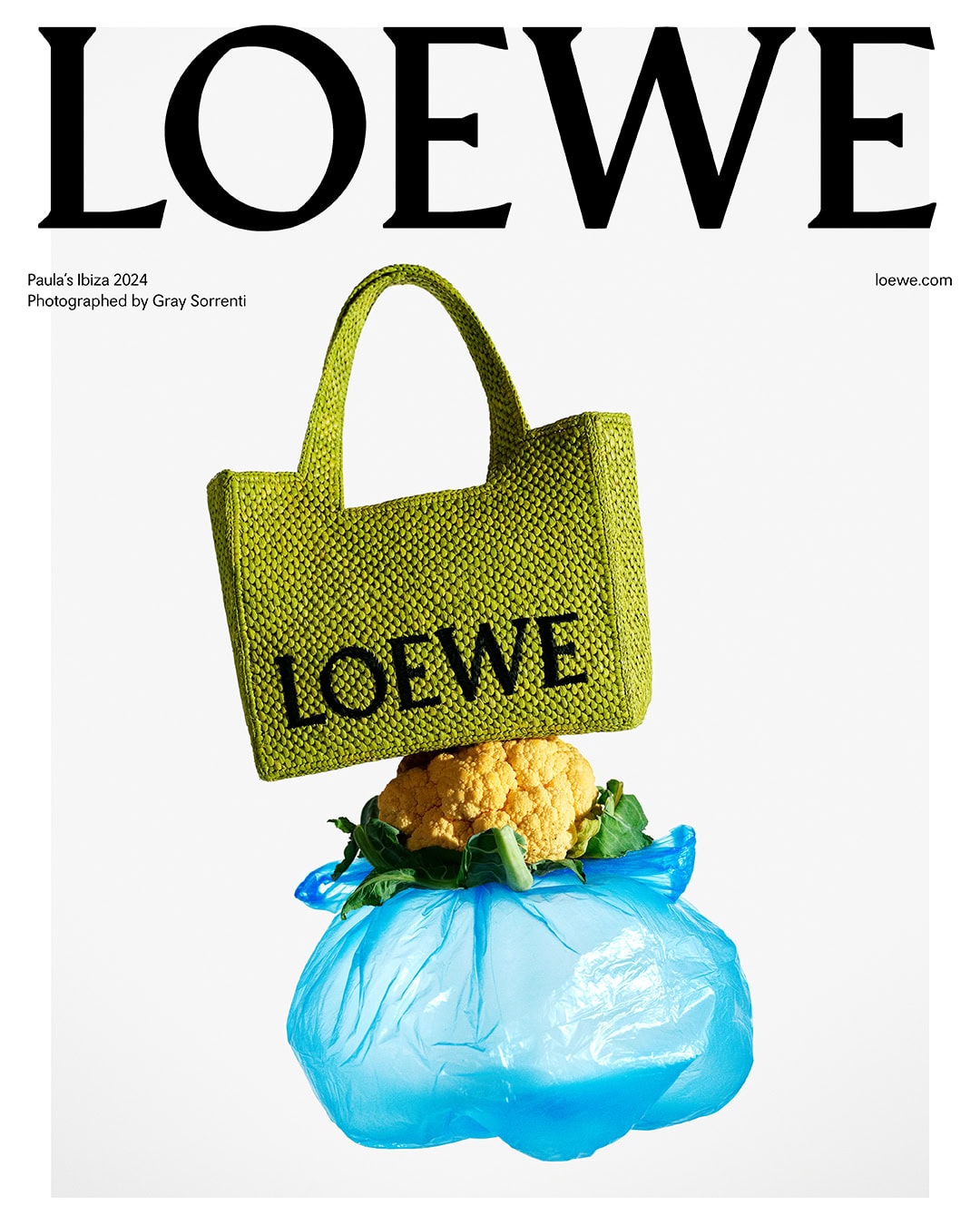 Loewe handbag on top of cauliflower and a plastic bag displayed against a white backdrop for Loewe Paula's Ibiza 2024 campaign.