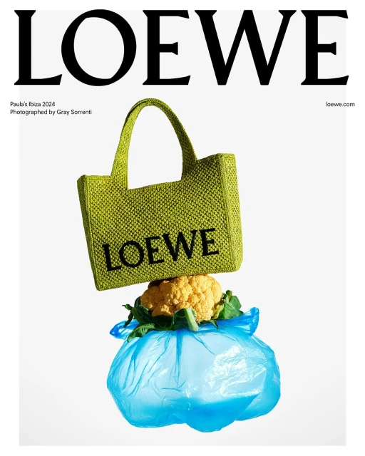 Loewe handbag on top of cauliflower and a plastic bag displayed against a white backdrop for Loewe Paula's Ibiza 2024 campaign.
