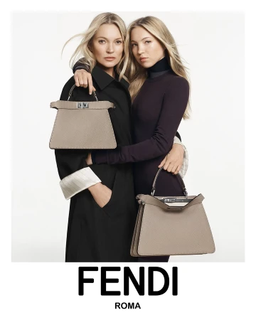Fashion shot of Kate Moss and Lila Moss modeling Fendi handbags in a studio, both posing in black attire against a white background.