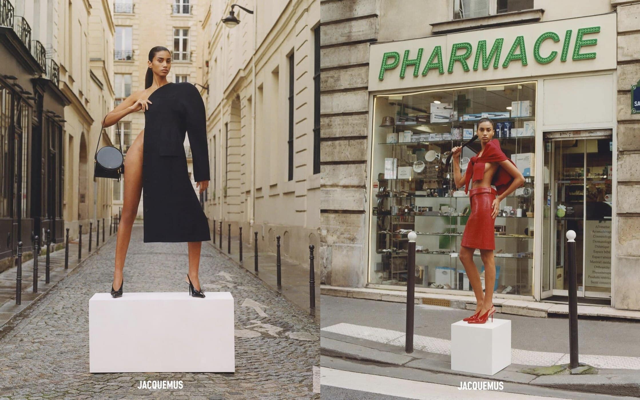Two fashion models pose on white cubes in a European street, wearing elegant outfits: a black coat dress and a red skirt set for a Jacquemus fashion shoot.
