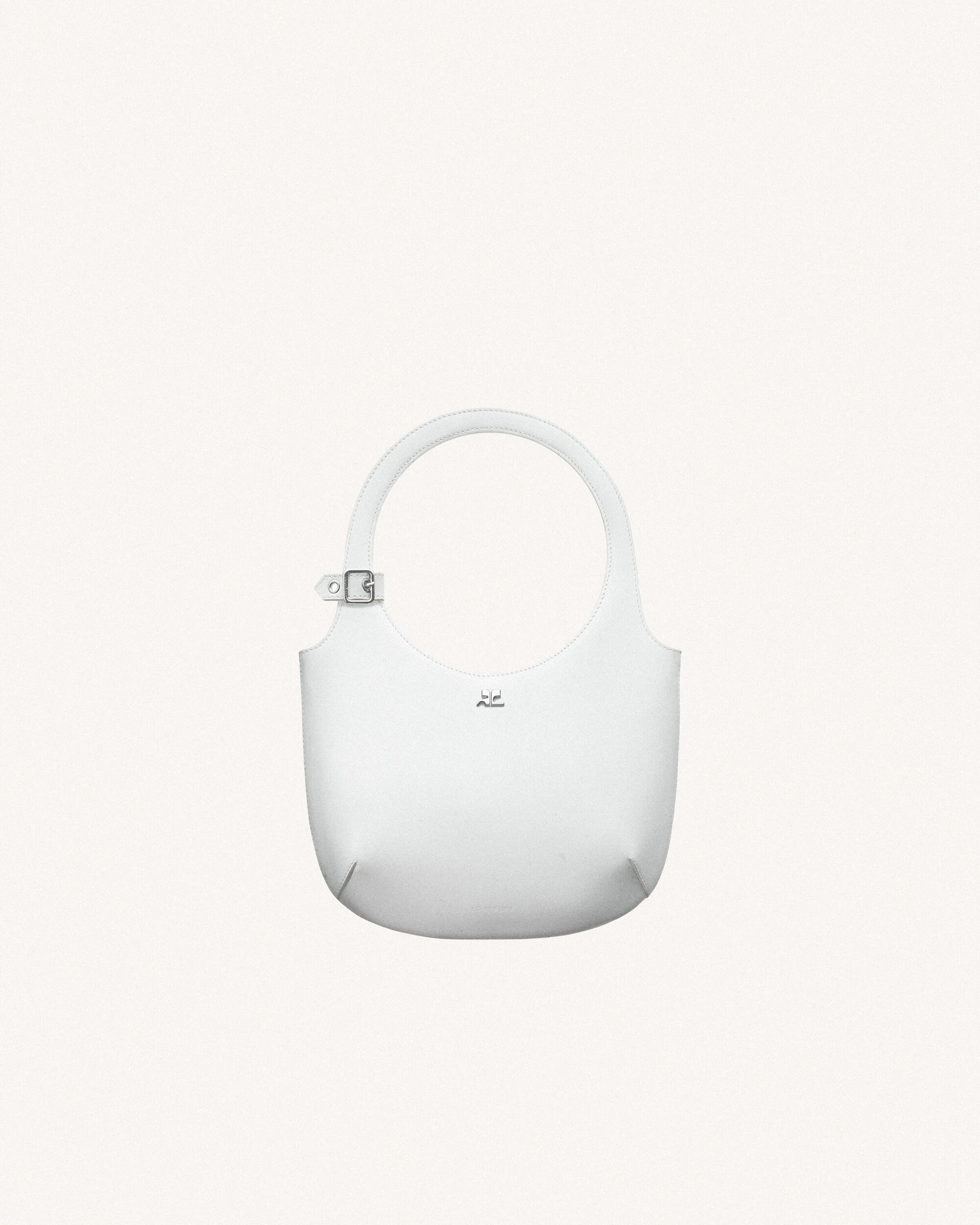 White leather handbag with rounded handle and metal buckle detail on a bright white background. Minimalist fashion accessory.