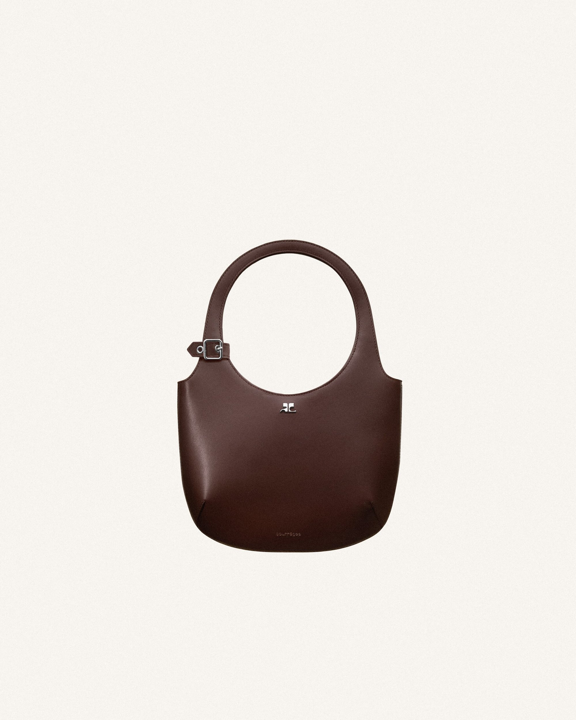 Studio shot of a dark brown leather hobo bag with a circular handle and a buckle detail, set against a neutral backdrop.