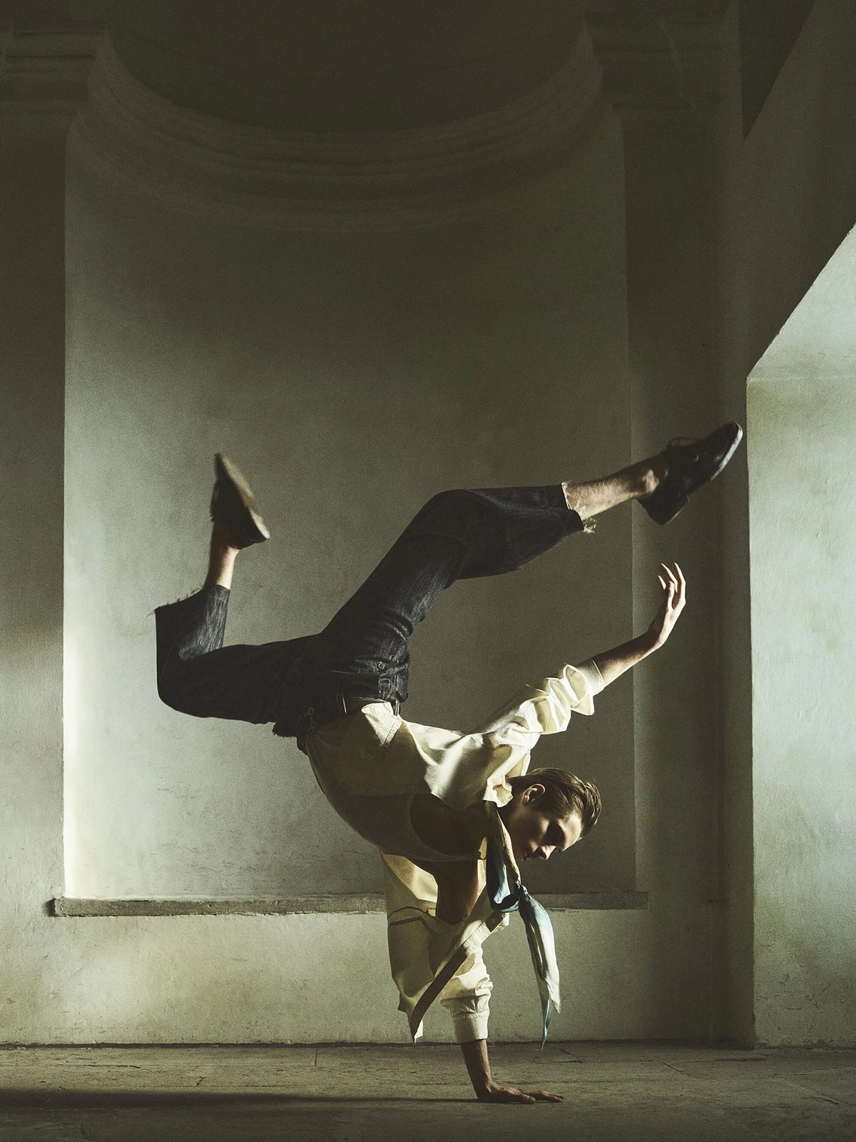 Male model performing a handstand freeze in an architectural interior for Zara spring campaign
