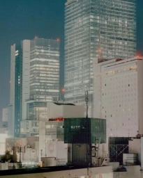 Night view of illuminated modern skyscrapers and urban architecture captured for Arcteryx Veliance Spring 25.