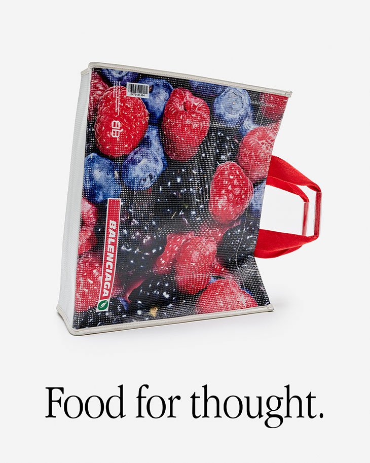 Balenciaga shopping bag with vivid berry print and red handles, presented on a clean white background, showcasing a modern aesthetic.