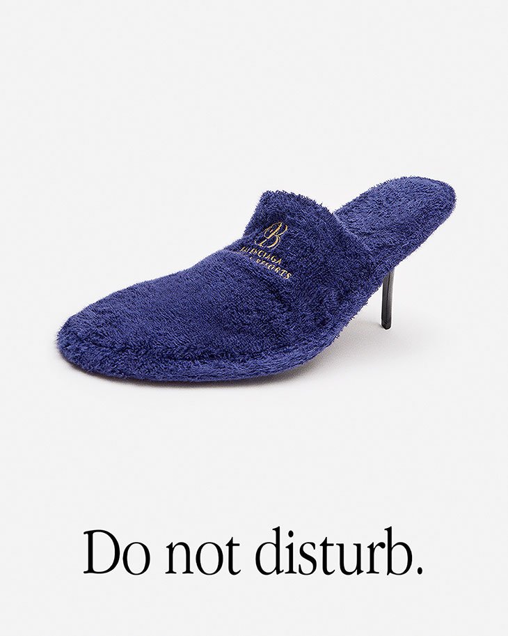 Elevated slipper with a heel, showcasing a blend of comfort and high fashion, set against a minimalist white backdrop, and the phrase 'Do not disturb'.