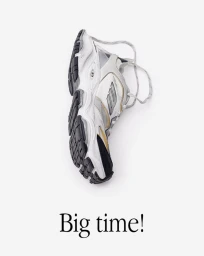 White and black chunky athletic sneaker shot vertically against a plain white background with text