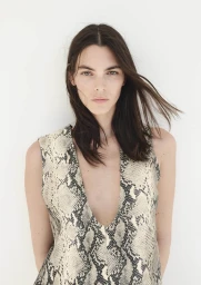 Vittoria Ceretti in a snakesprint sleeveless top against a plain white background for H and M Spring 2024 campaign