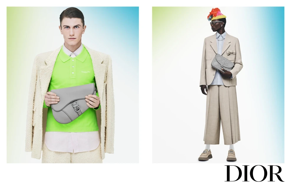 Fashion editorial featuring two models in neutral-toned outfits, each holding a gray handbag, set against a blended gradient background.
