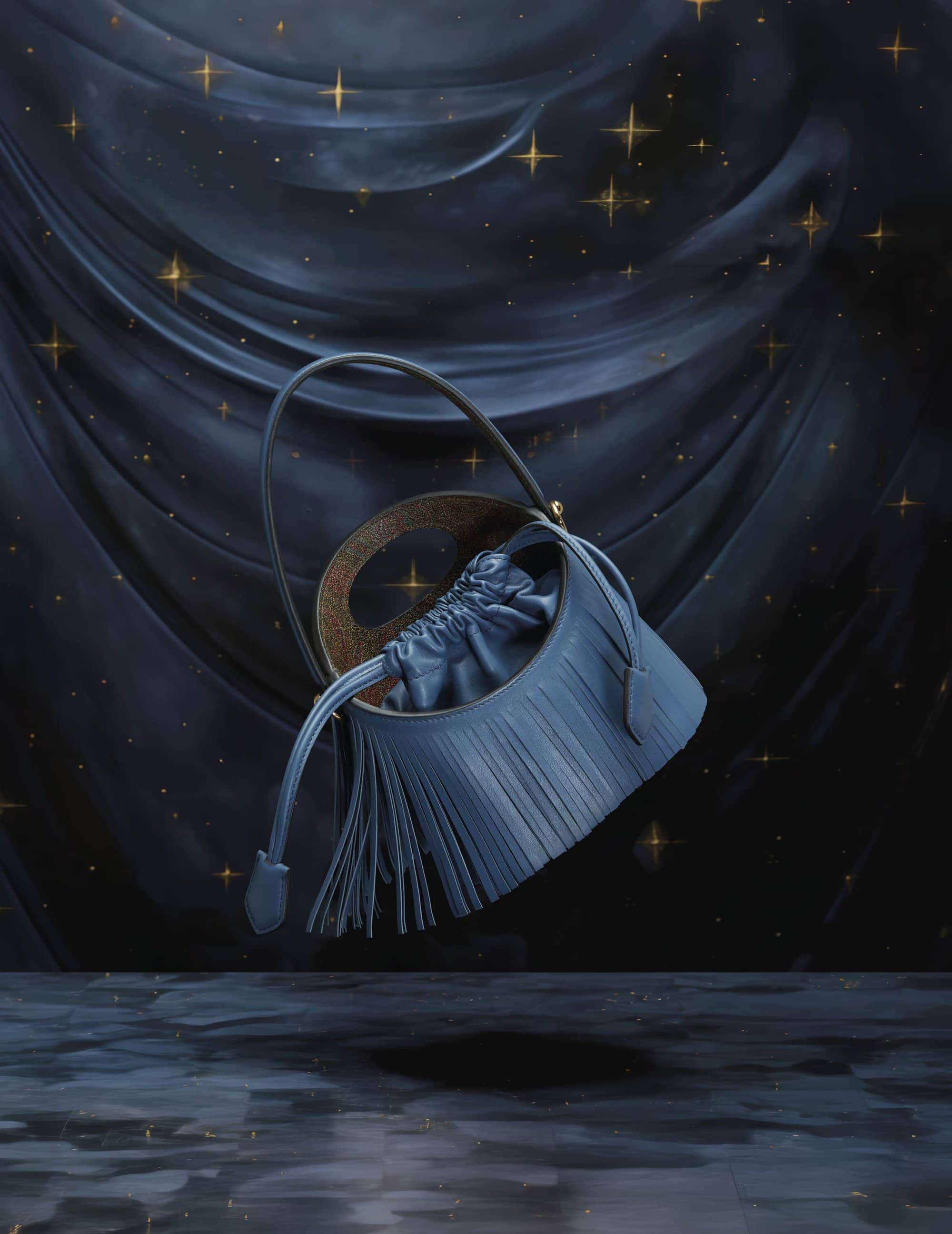 Elegant blue leather bucket bag with drawstring closure and a fringe detail, highlighted against a dark blue, star-studded backdrop.
