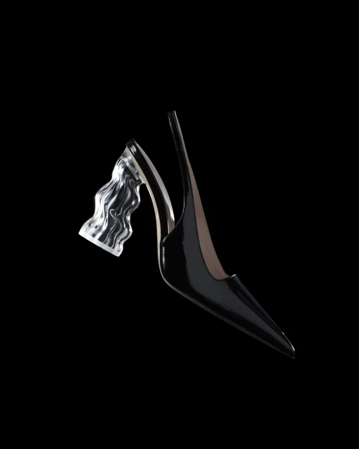 Elegant black slingback heel featuring a transparent, sculpted heel, set against a stark black backdrop. Fashion-forward footwear.