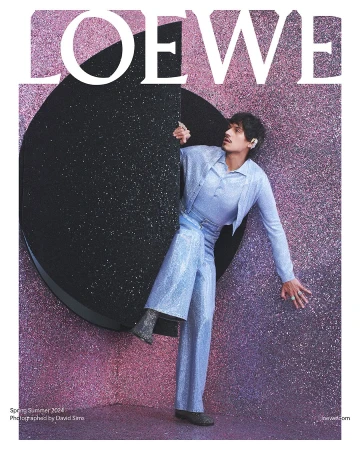 Fashion magazine cover featuring an androgynous male model in a glittery blue suit, posing against a sparkling backdrop with the LOEWE logo.