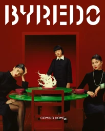 Three models posed around a red dining table with a green top against a deep red studio backdrop for Byredo