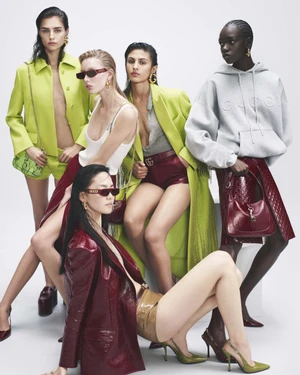 Group of five female models posing in Gucci Ancora 2024 campaign against white background wearing lime jackets and burgundy patent leather