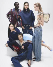 Group of models in designer denim and navy jackets posing against a clean white backdrop for Gucci Ancora ad campaign
