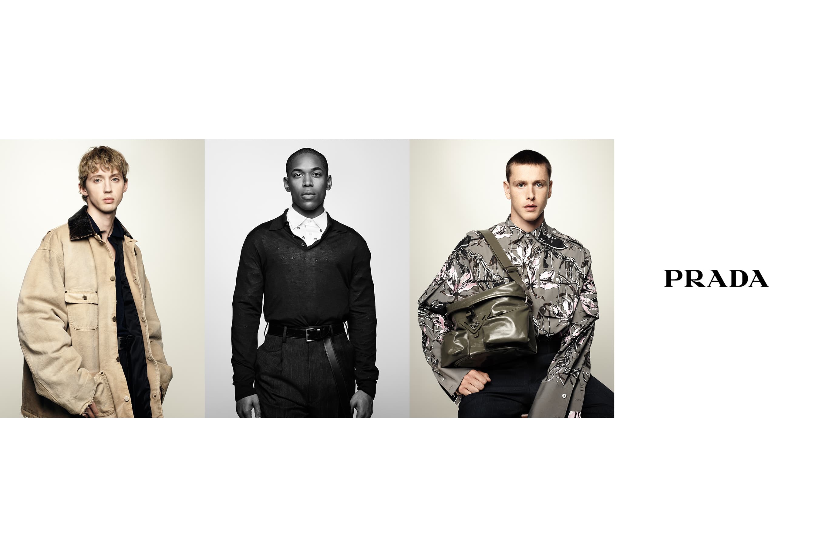 Three fashionably dressed male models showcasing Prada apparel in a photo studio, highlighting contemporary menswear and accessories.