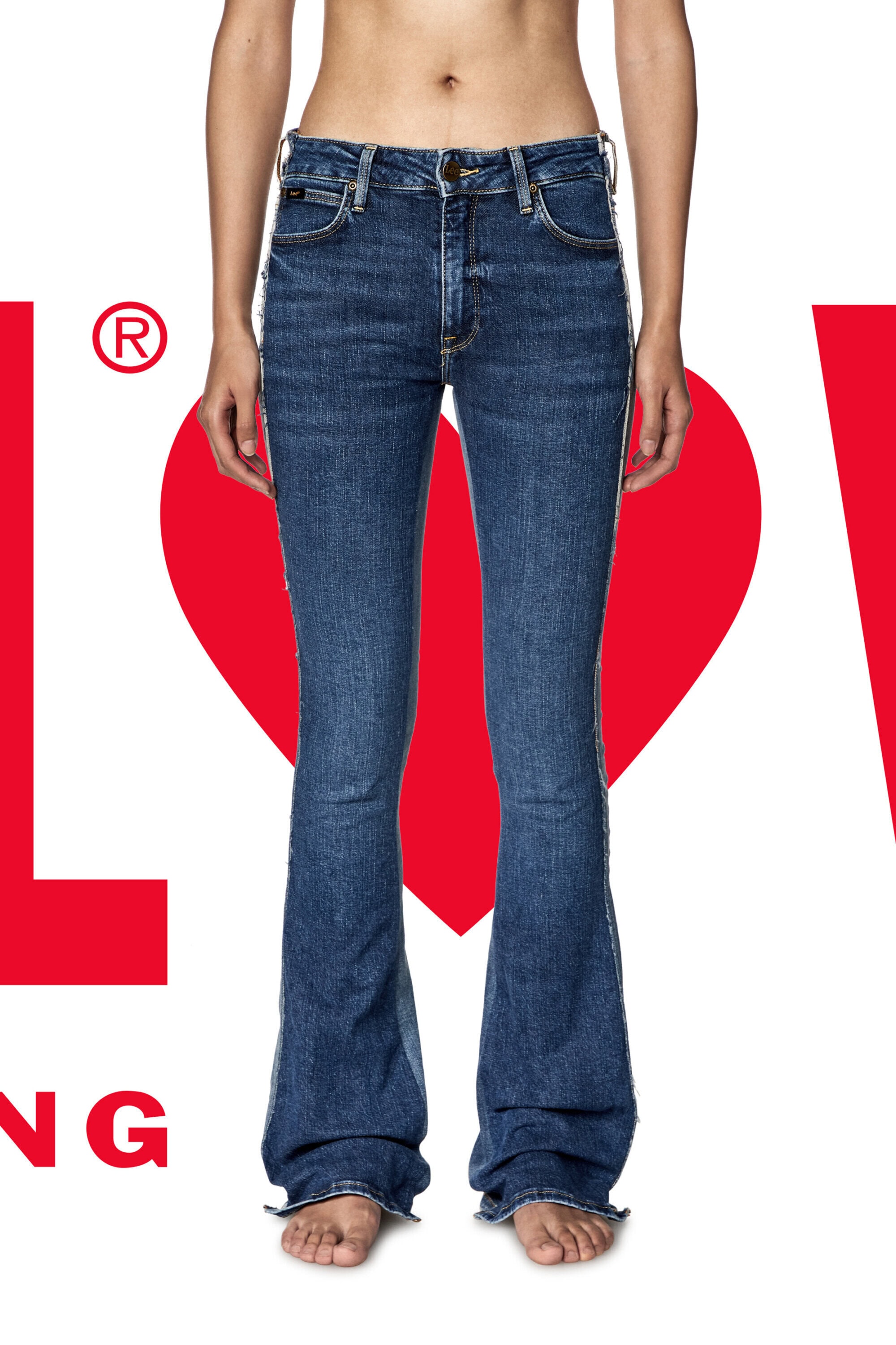 Jeans fashion shoot: A model displays a pair of dark-wash, flared denim jeans against a white background with red graphic elements.
