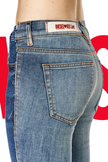 Close-up of light wash denim jeans on an adult female, featuring a branded patch with red text and a light background against white.
