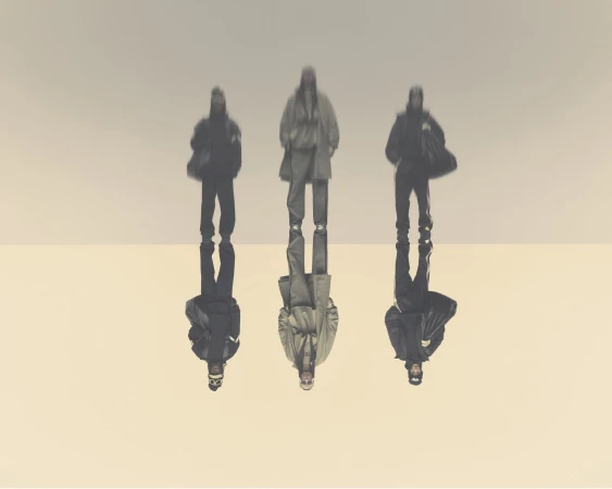 Three people stand in coordinated neutral-toned outfits with sharp reflections against a bright gradient backdrop in a fashion-forward editorial.