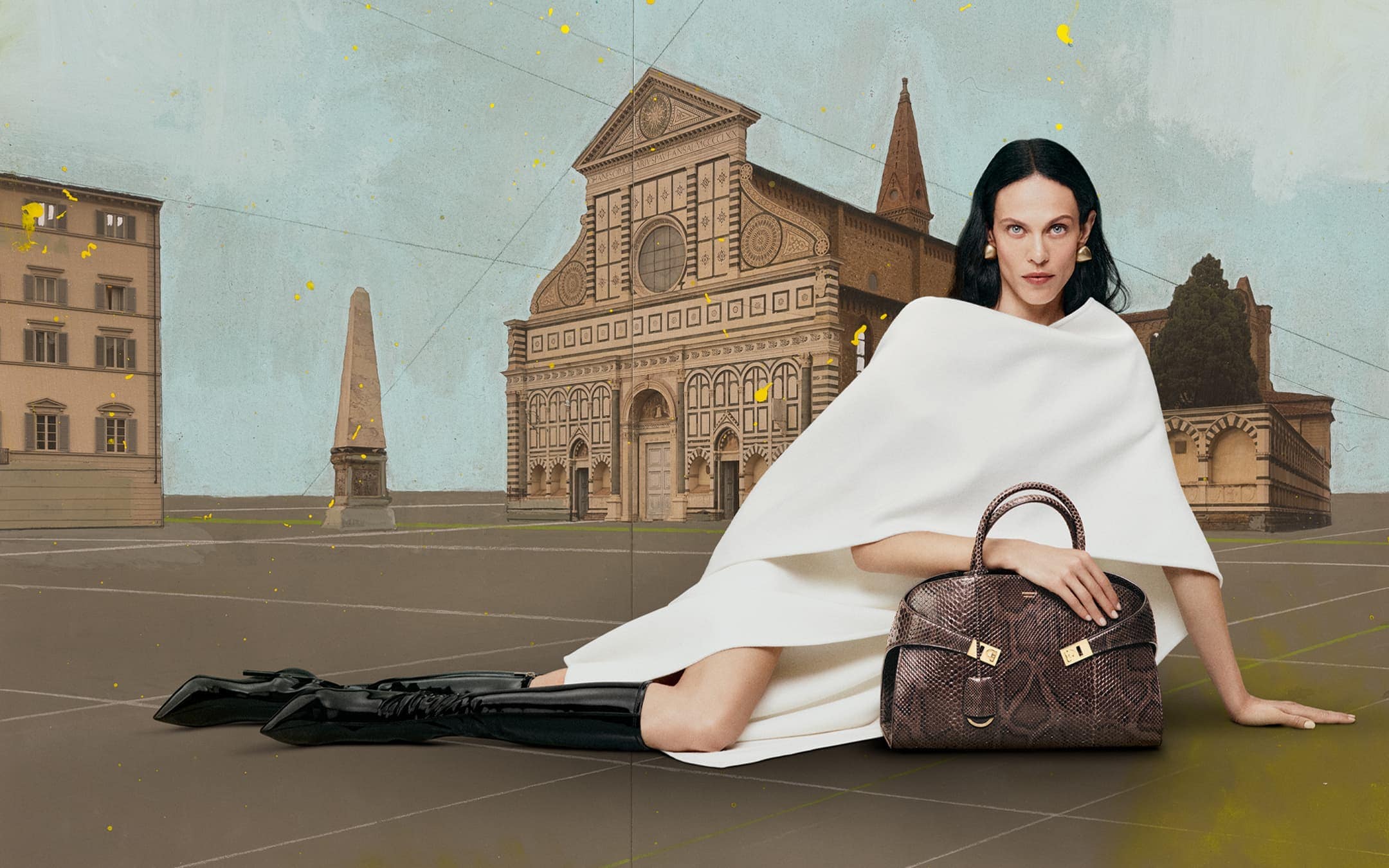 Fashion shot of an adult female in a white garment seated and posing with a handbag. The backdrop is a painted landscape.