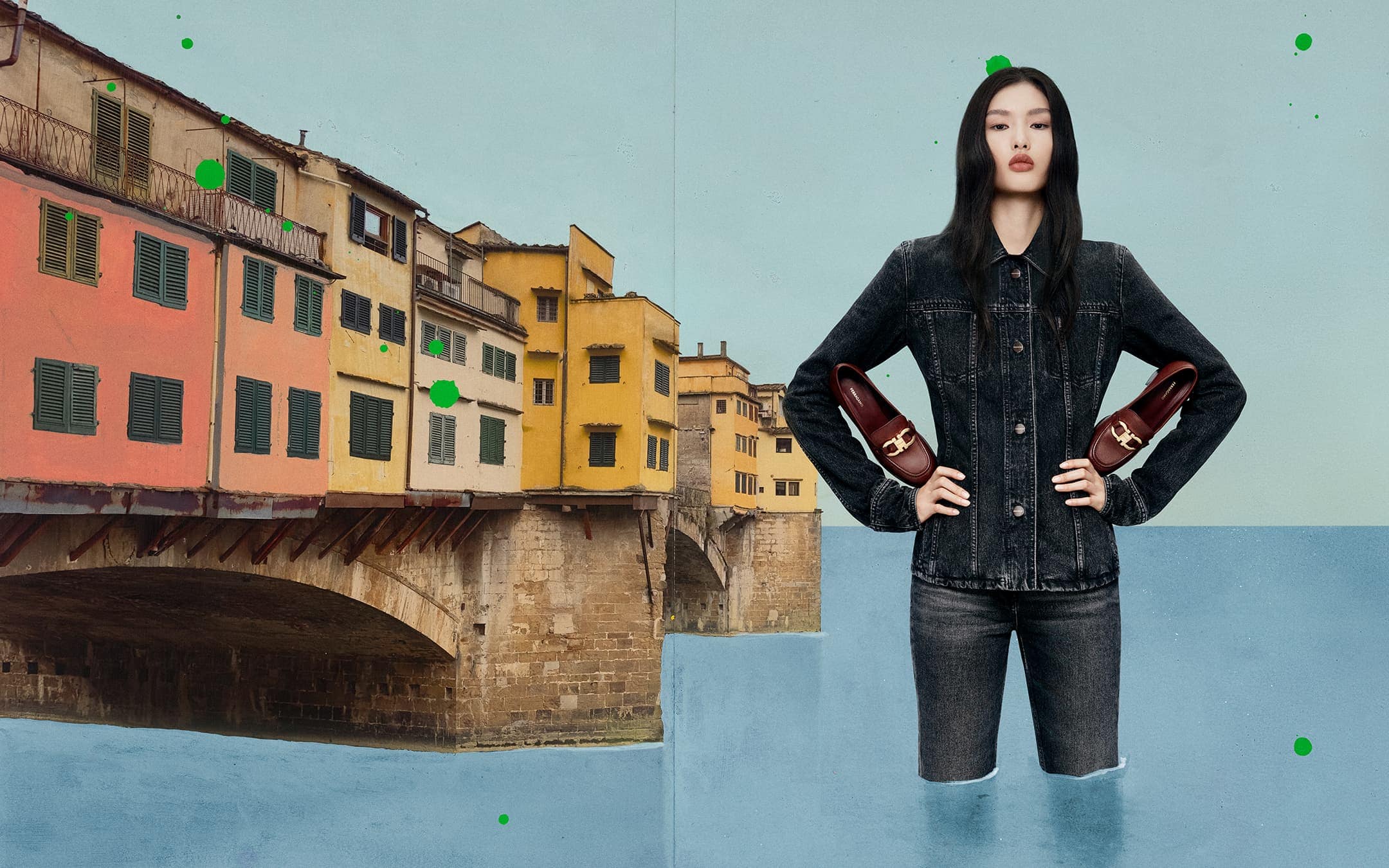 Fashion editorial shot of a woman in denim jacket and jeans holding a pair of loafers, set against the backdrop of a European city.