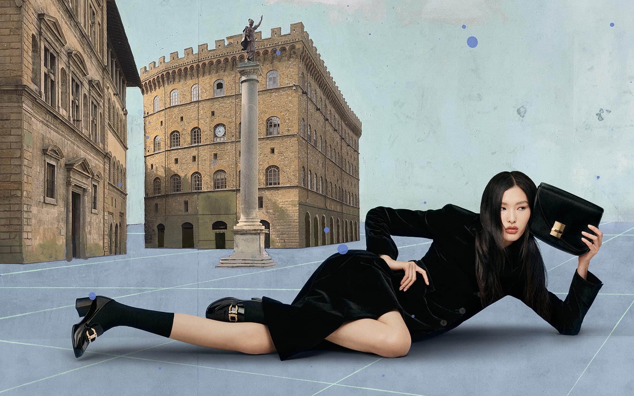 An Asian woman poses in black formalwear with a purse against a backdrop of vintage buildings, creating a high-fashion editorial image.