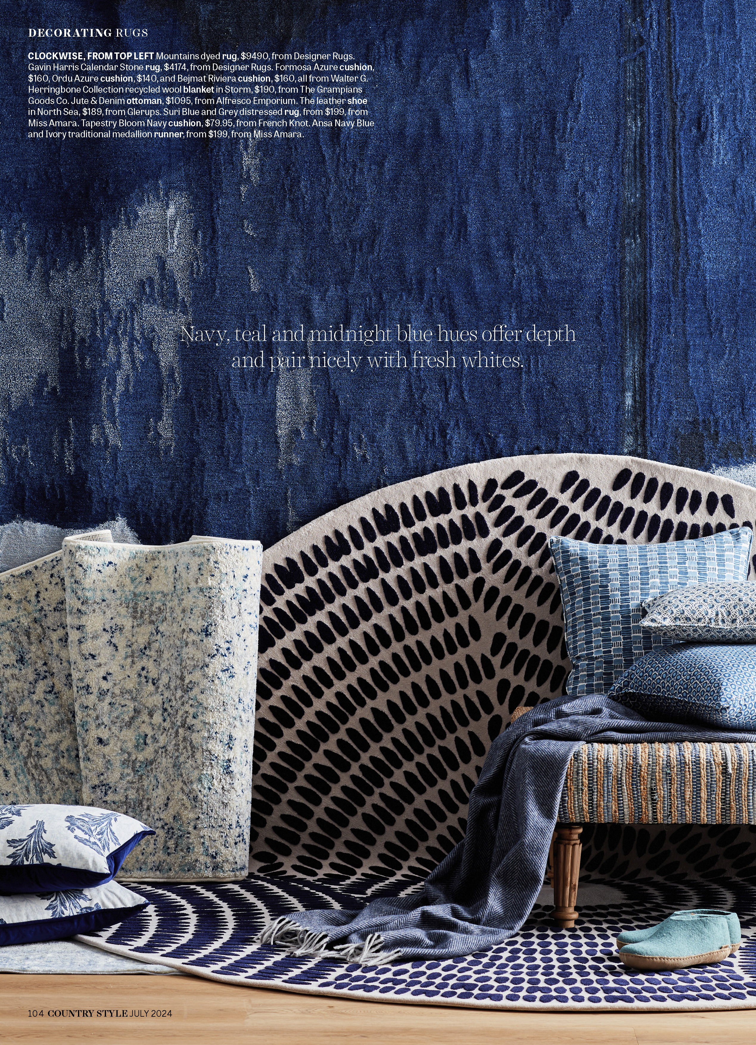 Interior design with various rugs and blue accent pillows create a cozy, textured space with complementary shades of blue and white.