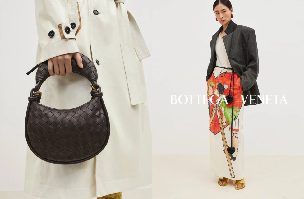 Fashion shot featuring a Bottega Veneta woven dark brown handbag against an off-white trench coat, alongside a woman in modern attire.