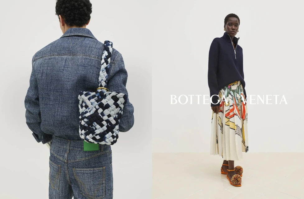 Fashion shot featuring a woman in a skirt and sweater and a person in a denim outfit with woven bag against a white backdrop.