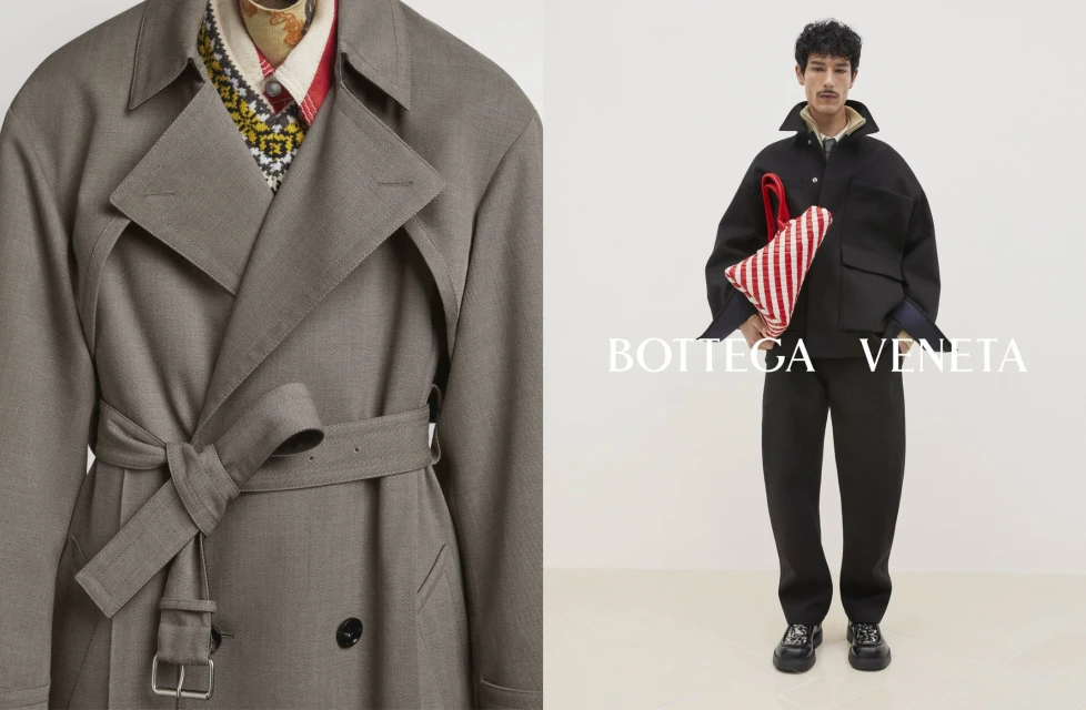 Fashion advertising shot of a tan trench coat and model in a black jacket and pants holding a red-and-white striped bag on a white background.