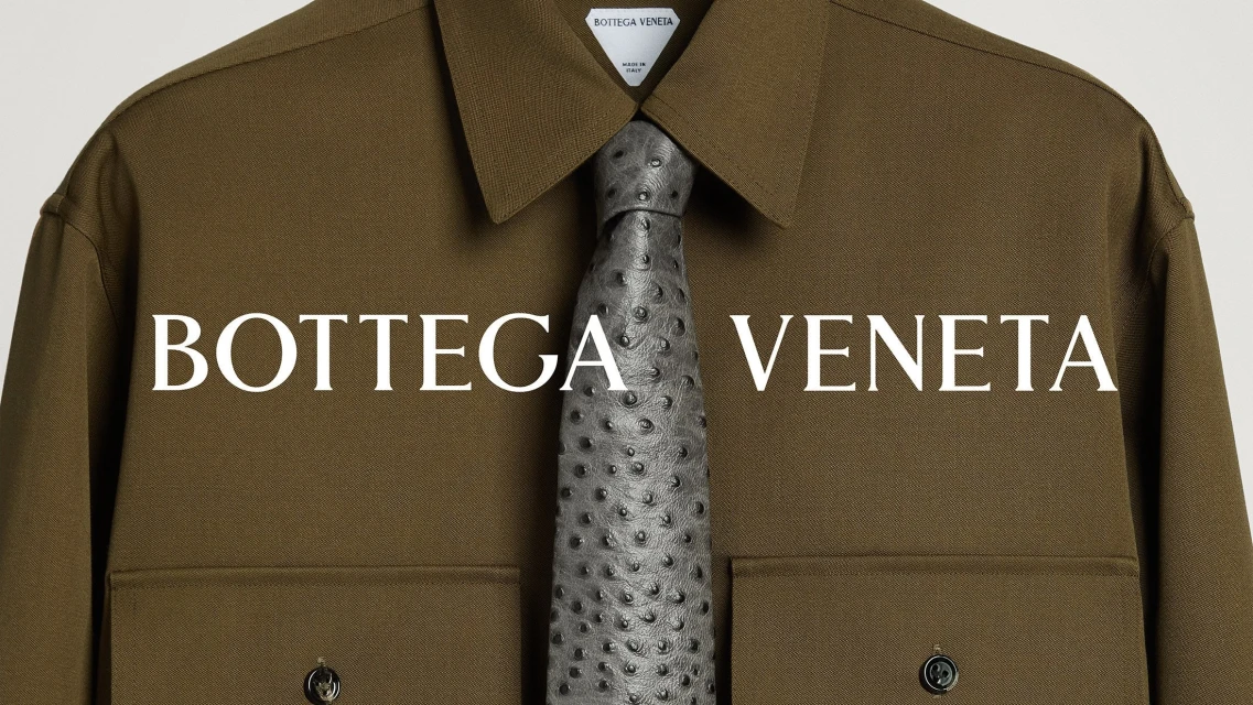 Olive green shirt with a textured grey tie by Bottega Veneta, against a clean, neutral background in a fashion product shot.