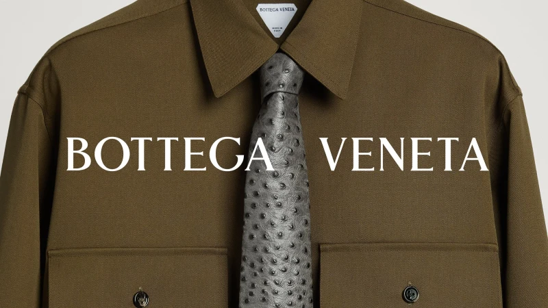 Olive green shirt with a textured grey tie by Bottega Veneta, against a clean, neutral background in a fashion product shot.