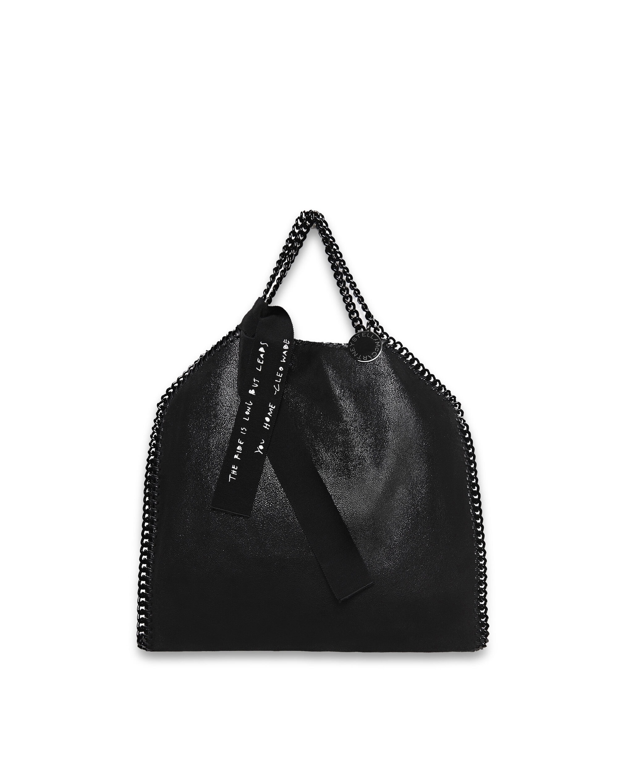 Black Stella McCartney Falabella tote bag with chain trim and shoulder straps, text on tag; studio shot on white background.