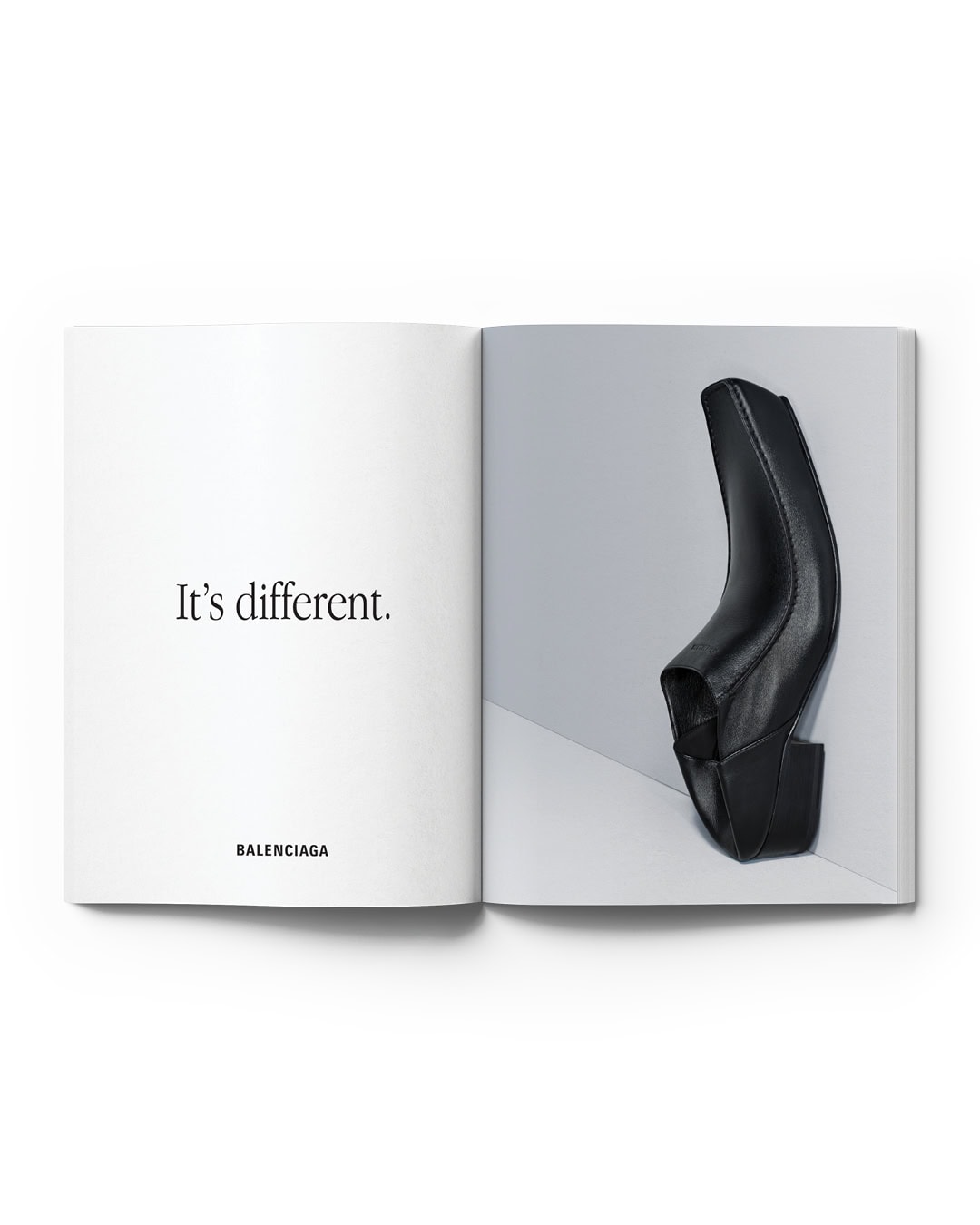 Open fashion magazine featuring a black leather ankle boot on a white and grey background, accompanied by the text 'It's different.'