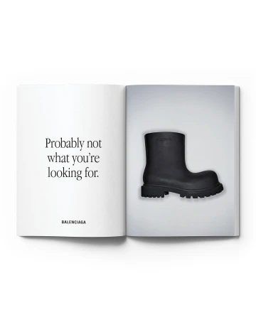 Balenciaga ad featuring a black boot. The ad displays the boot on the right page and a quote, 'Probably not what you're looking for,' on the left.