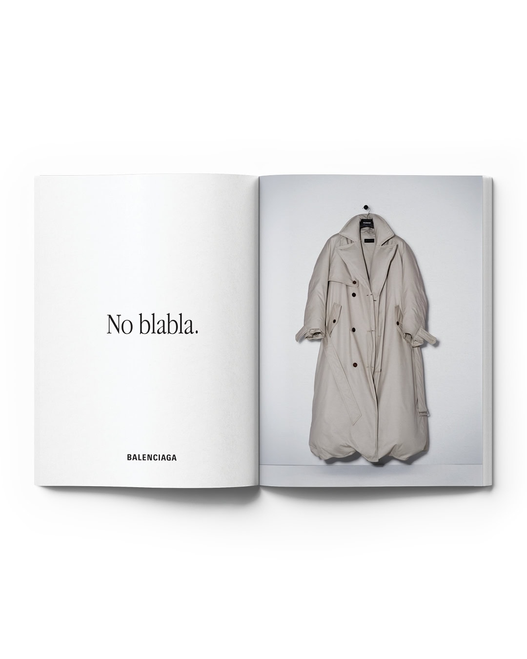 Fashion editorial featuring a spread in an open book with a beige trench coat on a hanger against a white wall, with 'No blabla' text.