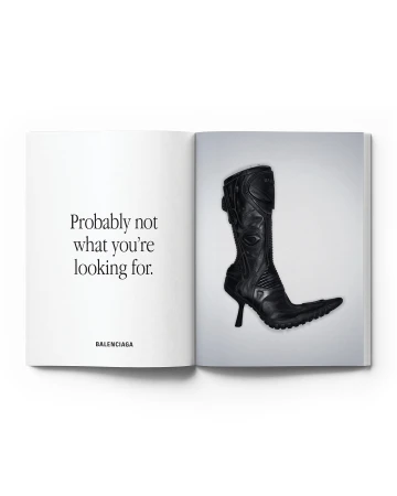 Black leather high-heel boot displayed on a page of an open magazine with a white background and the text 'Probably not what you're looking for'.