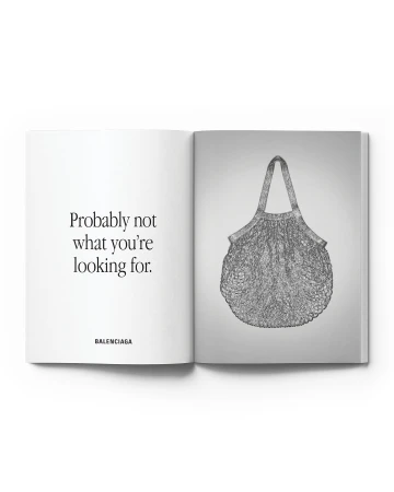 Open magazine spread featuring a sketched handbag on the right page and brand text on the left page, set against a clean white background.