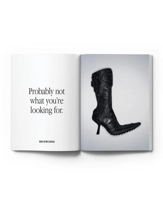 Open magazine spread showing a black high-heeled motorcycle boot beside text reading 'Probably not what you're looking for.' and Balenciaga.