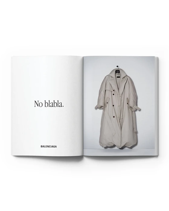 Open magazine spread featuring Balenciaga slogan No blabla on the left page and an oversized beige puffer trench coat on the right.