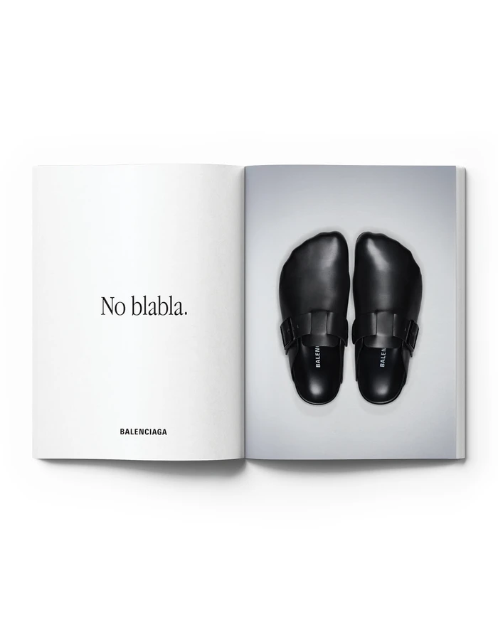 Balenciaga print advertisement spread featuring black leather buckle clogs beside the text No blabla on an open book layout.