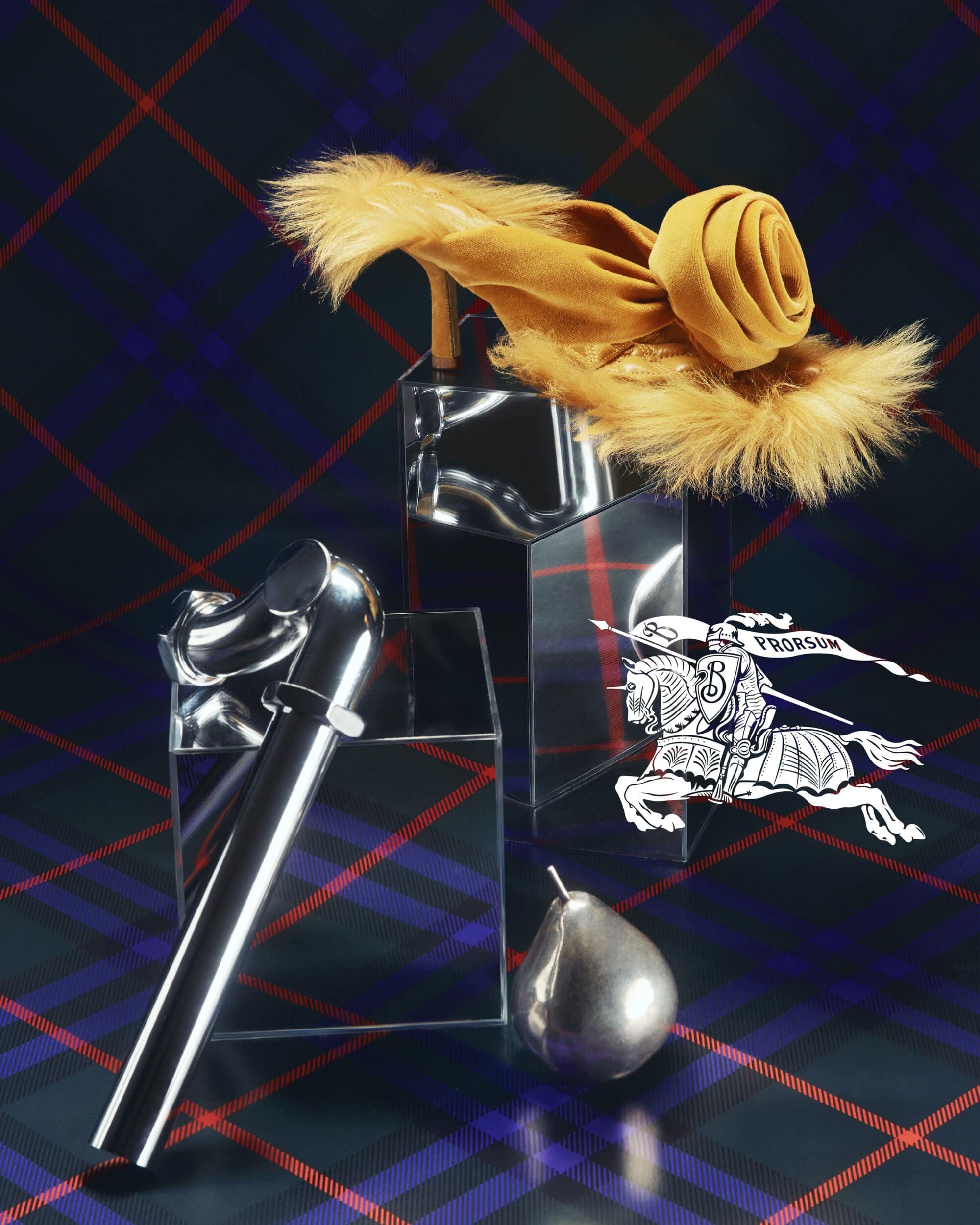 High-heeled shoe with floral adornment and silver cane on reflective pedestals against a plaid backdrop.