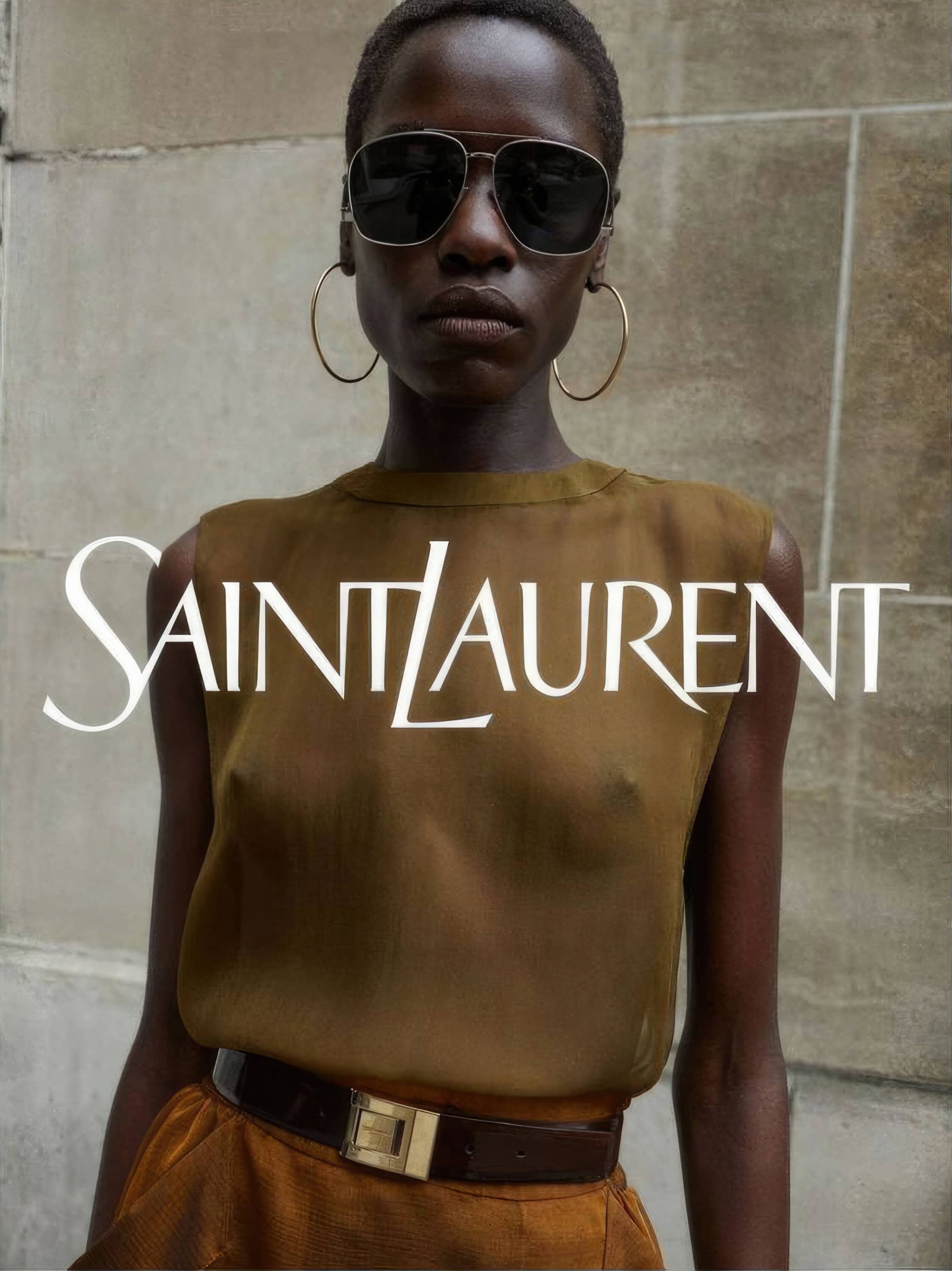 Dark-skinned woman in sunglasses and sheer top. Saint Laurent logo overlay, fashion, portrait, close-up shot, studio background.