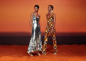 Two models standing on a sandy terrain against a sunset sky for the Rabanne x HM campaign photographed by Craig McDean