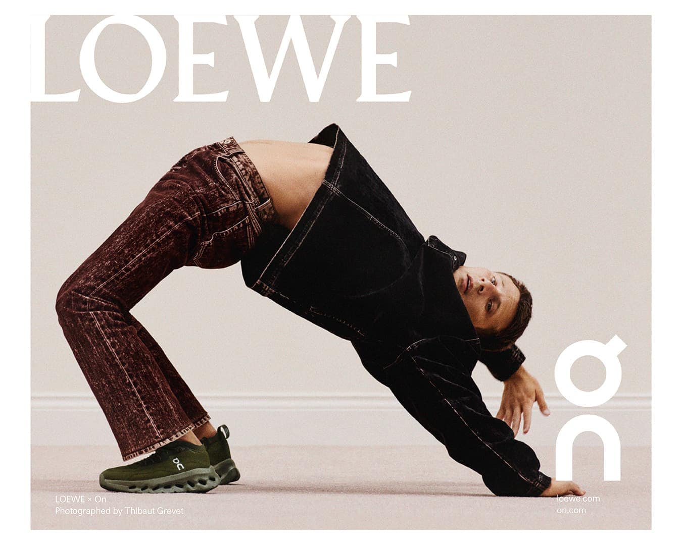 Fashion-forward ad featuring a man in a backbend wearing a dark denim jacket, brown jeans, and green athletic shoes, showcasing the LOEWE and On brands.