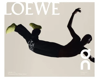 A silhouetted man in mid-air wearing dark trousers and bright lime green sneakers against a minimalist neutral studio background.